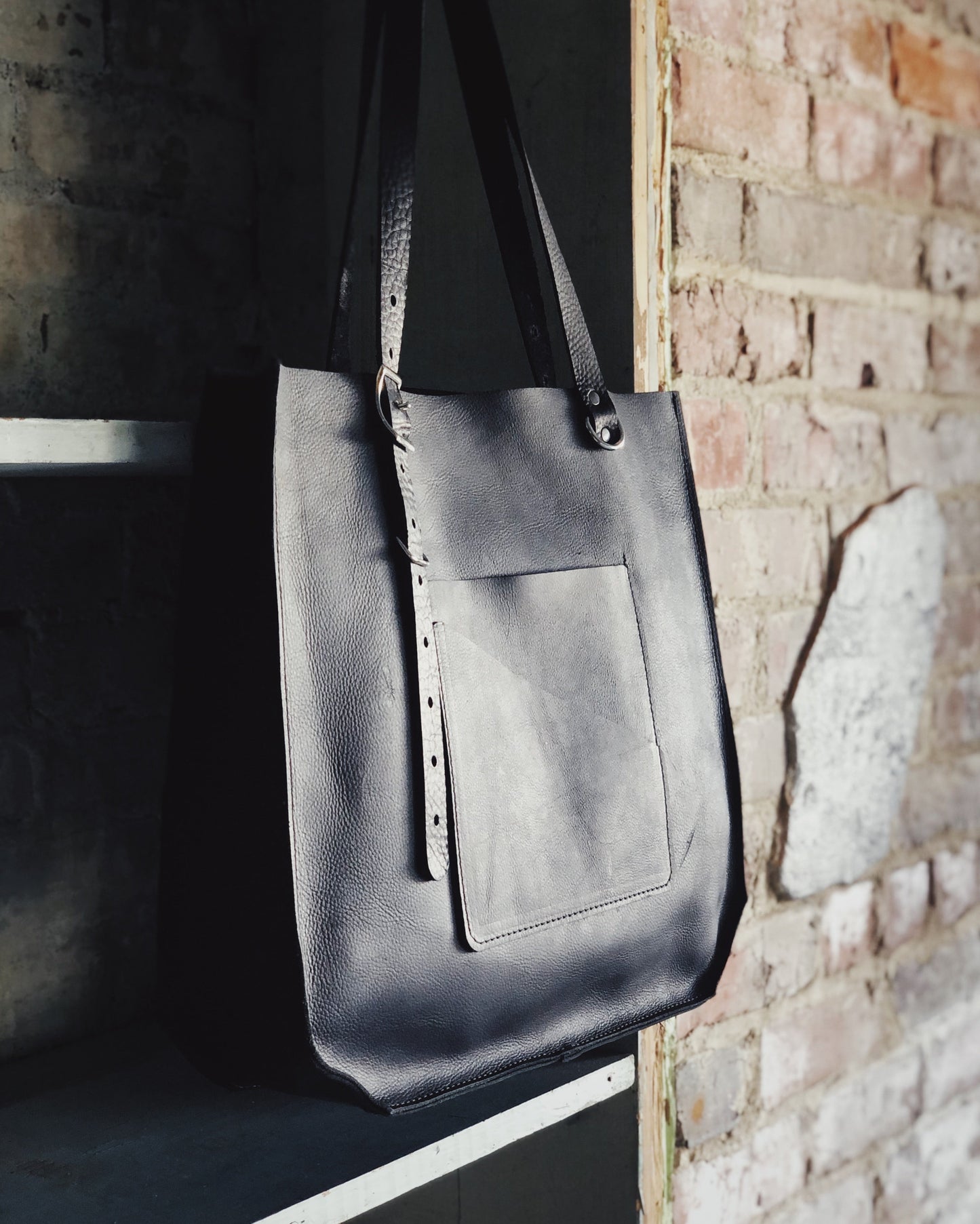 The Wander Black Leather Hand Bag
