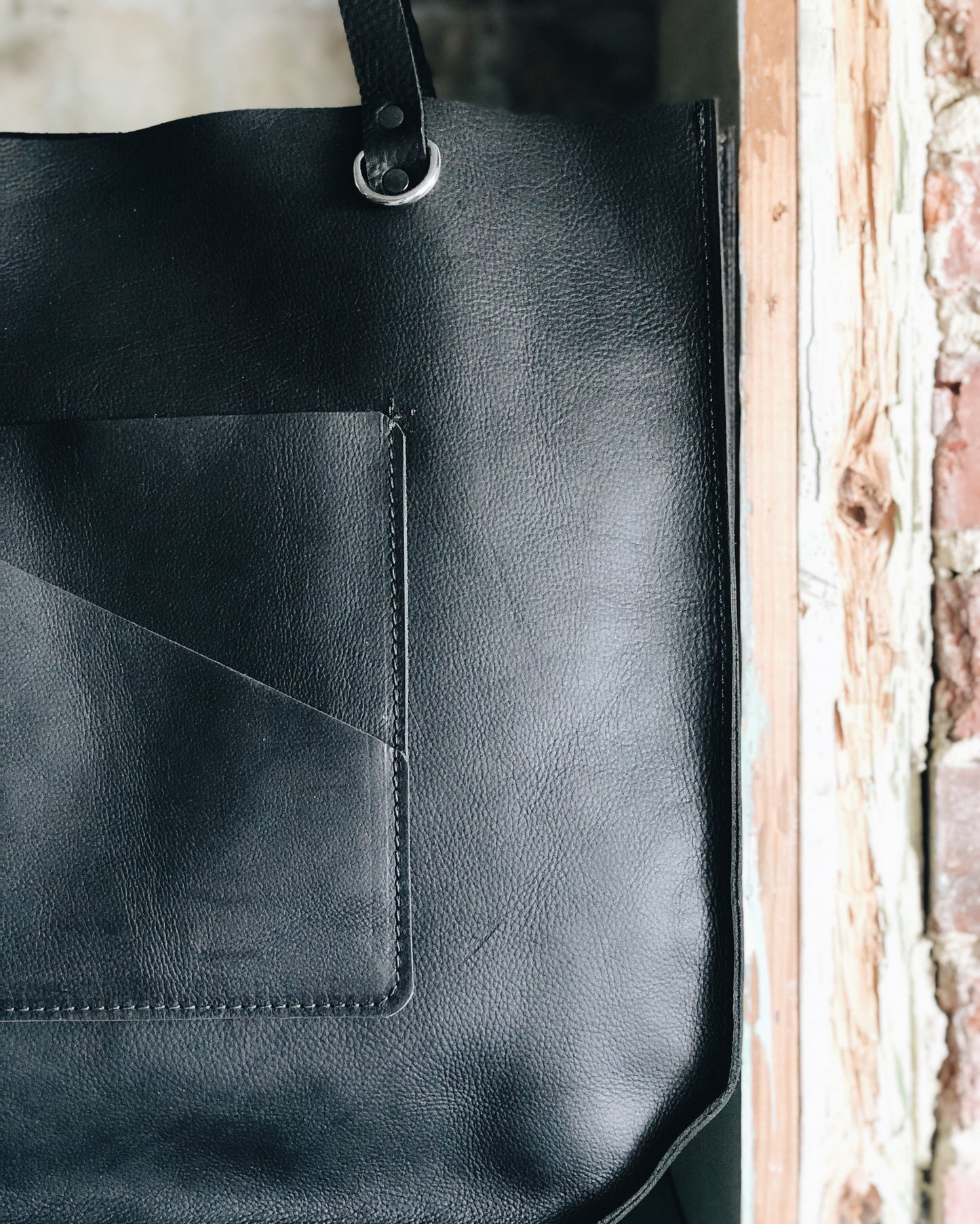 The Wander Black Leather Hand Bag