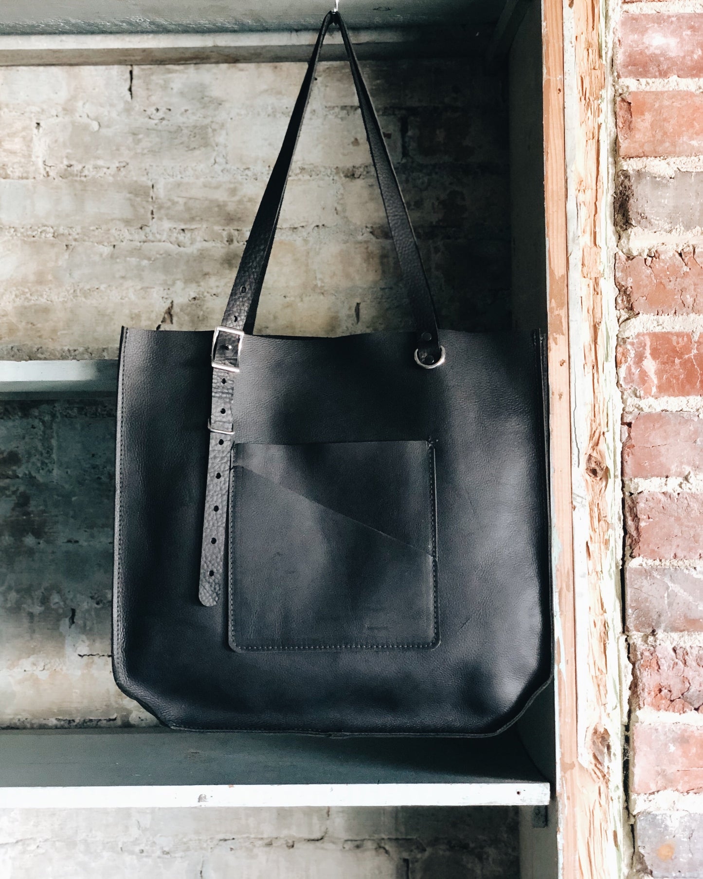 The Wander Black Leather Hand Bag