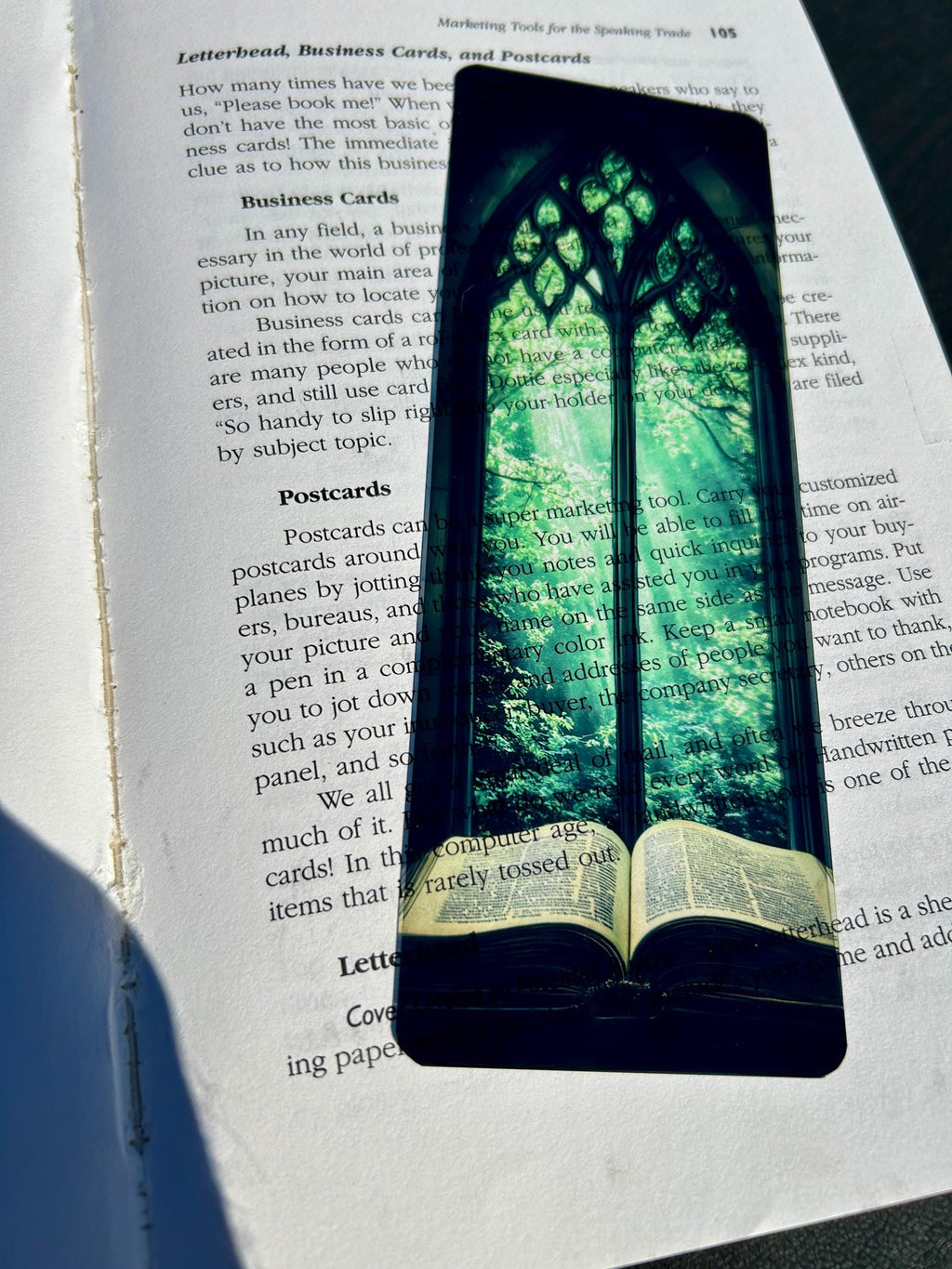 Bible Bookmark – Stained Glass Window Arch with Green Canopy & Glowing Light Over Ancient Open Book