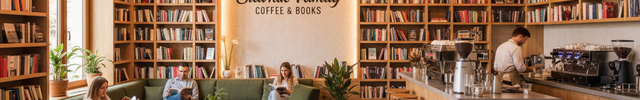 modern coffee shop with books and text "Slavnik Family Coffee & Books" in the center